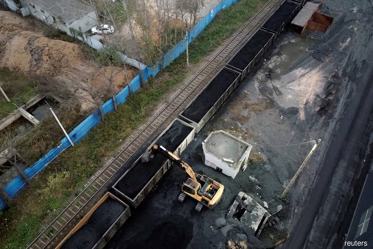 An excavator loads coal onto a train in Pingdingshan, Henan province November 4, 2021. (Reuters pic)